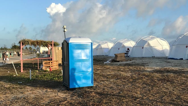So much for luxury 'villas.' Tents and a portable toilet greeted attendees for the Fyre Festival, April 28, 2017 in the Exuma islands, Bahamas.