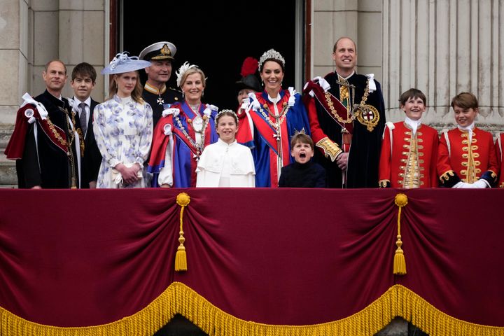 Louis makes another great face during the flypast over Buckingham Palace, as his brother George looks at him with a grin. 